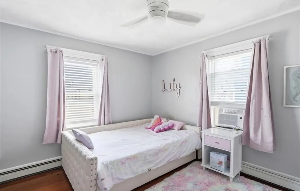 Child's bedroom with soft pink curtains and daybed